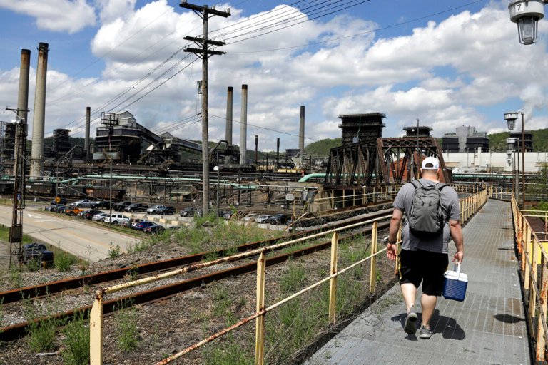 In this May 2, 2019, file photo, a worker arrives for his shift at the U.S. Steel Clairton Coke Works in Clairton, Pa. 