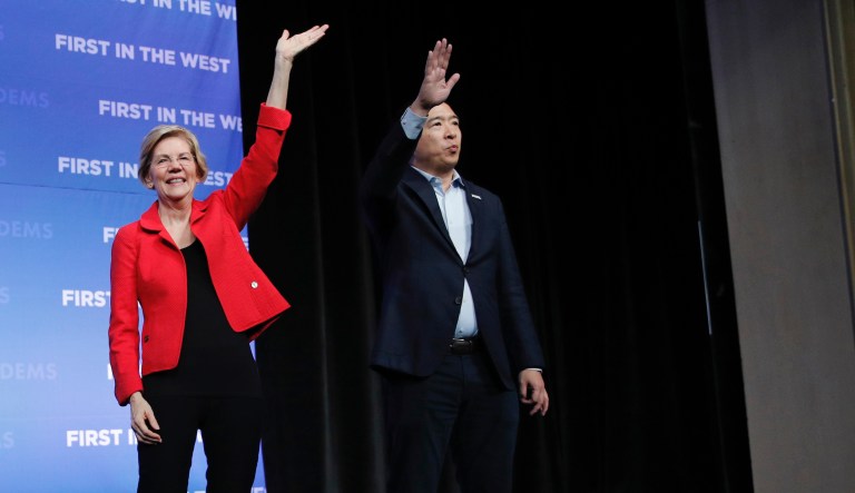 From left, Democratic presidential candidate  South Bend Mayor Pete Buttigieg, Sen. Elizabeth Warren, D-Mass., and businessman Andrew Yang stand on stage during a fundraiser for the Nevada Democratic Party, Sunday, Nov. 17, 2019, in Las Vegas.