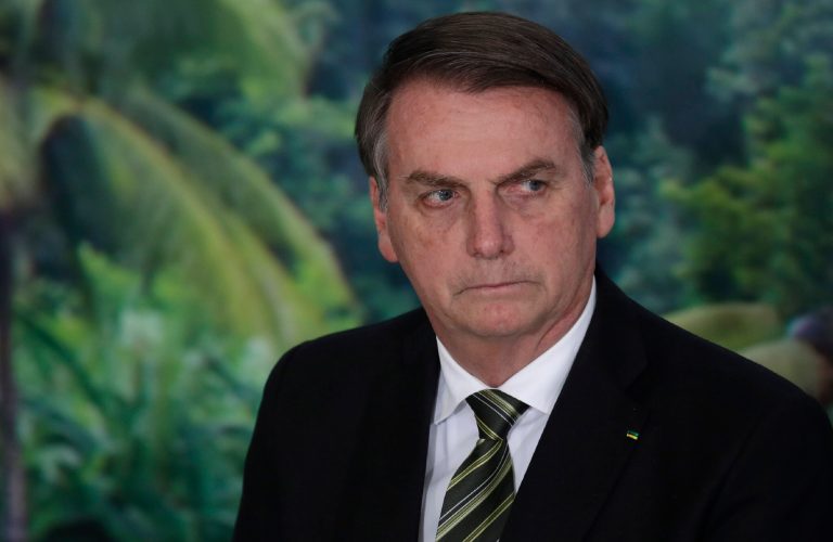 FILE - In this Oct. 1, 2019 file photo, President Jair Bolsonaro attends a ceremony to launch an agro program at the Planalto presidential palace in Brasilia, Brazil. Bolsonaro lashed out at journalists on Friday, Dec. 20 singling out one as looking like a homosexual, as news reports of a corruption investigation linked to his son continued making headlines. 