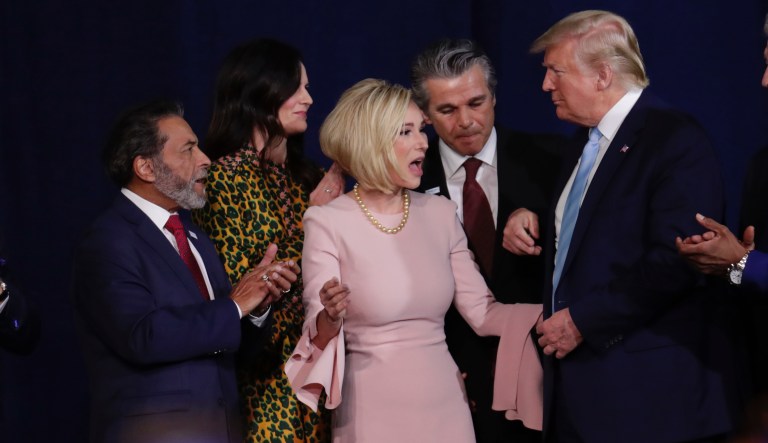 Pastor Paula White, second from left, stands with President Donald Trump during a rally for evangelical supporters at the King Jesus International Ministry church, Friday, Jan. 3, 2020, in Miami.