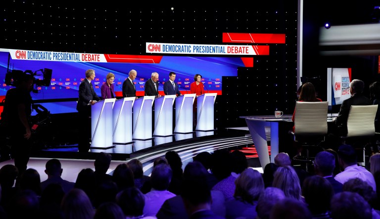 From left, Democratic presidential candidates businessman Tom Steyer, Sen. Elizabeth Warren, D-Mass., former Vice President Joe Biden, Sen. Bernie Sanders, I-Vt., former South Bend Mayor Pete Buttigieg, and Sen. Amy Klobuchar, D-Minn. are seen Tuesday, Jan. 14, 2020, during a Democratic presidential primary debate hosted by CNN and the Des Moines Register in Des Moines, Iowa.