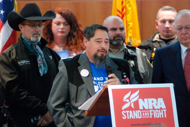 Mayor Nathan Dial of Estancia, N.M., center, speaks at a news conference about gun legislation on Friday, Jan. 31, 2020, in Santa Fe, N.M., as hundreds of advocates for 2nd Amendment rights rallied outside the Statehouse against a proposed red-flag gun law.