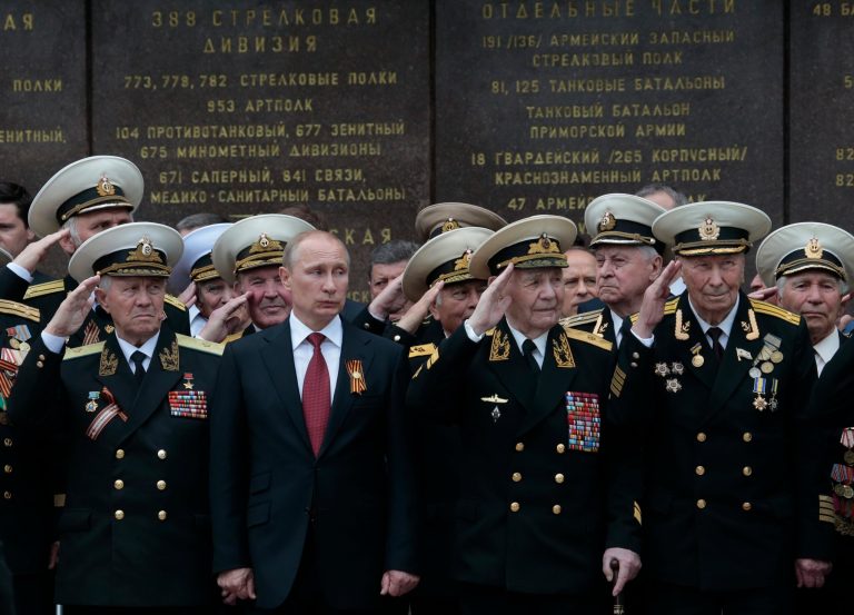 In this May 9, 2014 file photo, Russian President Vladimir Putin attends a parade marking the Victory Day in Sevastopol, Crimea.  Russia's annexation of the Crimea region of Ukraine in March 2014 marked the climax of President Vladimir Putin's quest to restore Moscow's influence over its neighbors and reverse decades of perceived humiliation at the hands of the West.