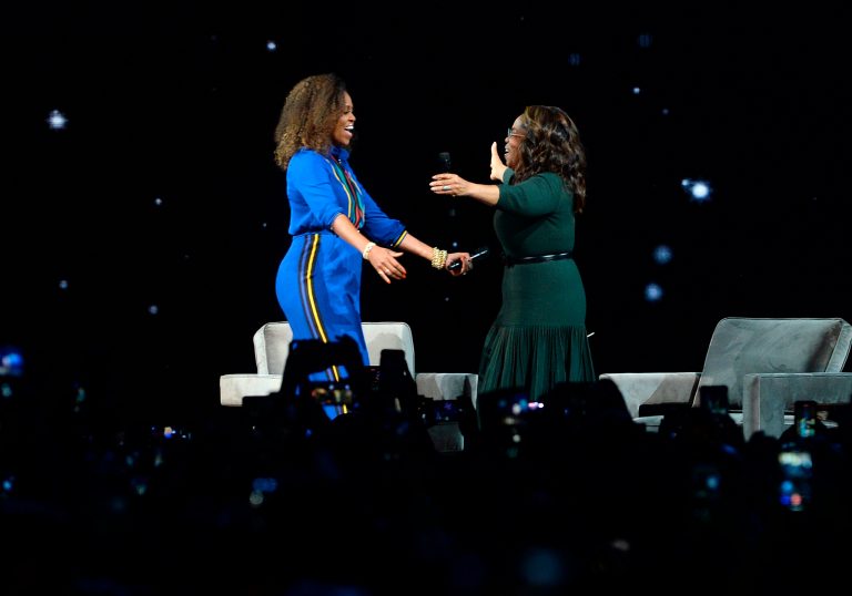 Michelle Obama, left, and Oprah Winfrey greet each other onstage at "Oprah's 2020 Vision: Your Life in Focus" tour at the Barclays Center on Saturday, Feb. 8, 2020, in New York. A new group to draft Obama as Joe Biden's running mate has formed.