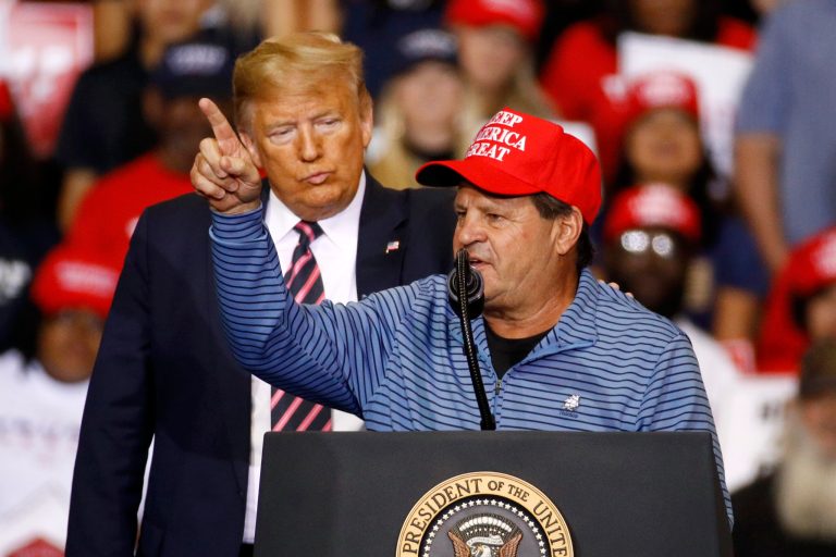 President Donald Trump listens as Mike Eruzione, captain of the 1980 U.S men's Olympic hockey team, speaks during a campaign rally, Friday, Feb. 21, 2020, in Las Vegas.