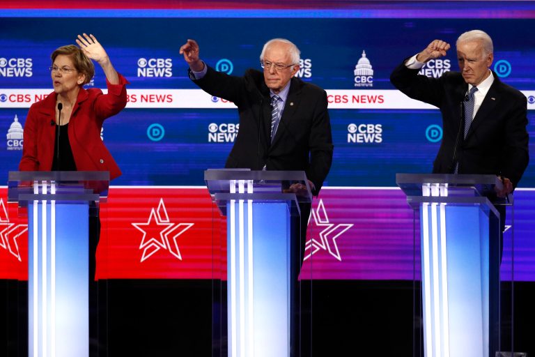 From left, Democratic presidential candidates, Sen. Elizabeth Warren, D-Mass., Sen. Bernie Sanders, I-Vt., and former Vice President Joe Biden try to answer a question during a Democratic presidential primary debate at the Gaillard Center, Tuesday, Feb. 25, 2020, in Charleston, S.C.