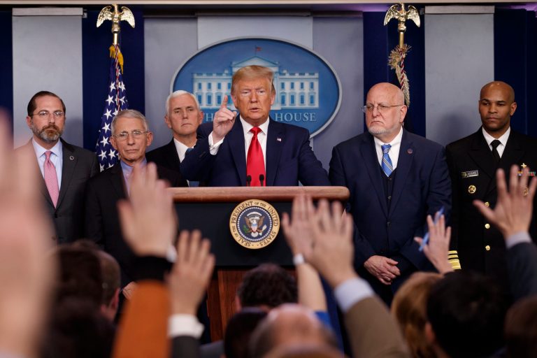 President Donald Trump, center, points as he prepares to answer question after speaking about the coronavirus in the press briefing room at the White House, Saturday, Feb. 29, 2020, in Washington, as Health and Human Services Secretary Alex Azar, National Institute for Allergy and Infectious Diseases Director Dr. Anthony Fauci, Vice President Mike Pence, Robert Redfield, director of the Centers for Disease Control and Prevention and U.S. Surgeon General Dr. Jerome Adams listen.