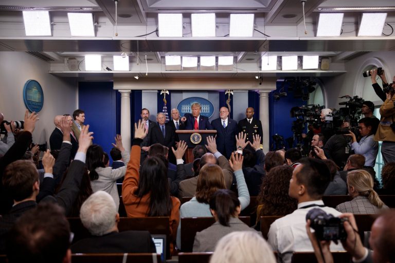 President Donald Trump, center, points as he prepares to answer question after speaking about the coronavirus in the press briefing room at the White House, Saturday.