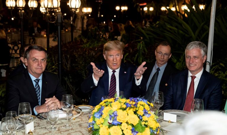 President Donald Trump speaks before a dinner with National Security Adviser Robert O'Brien, right, and Brazilian President Jair Bolsonaro, left, at Mar-a-Lago in March