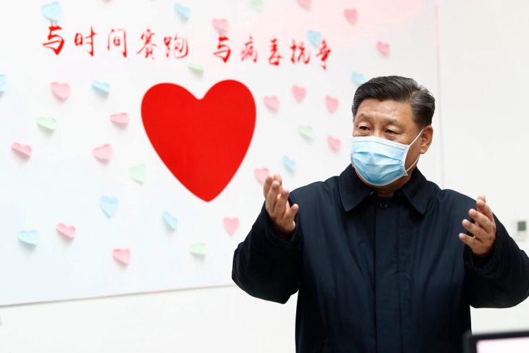Chinese President Xi Jinping gestures near a heart shape sign and the slogan "Race against time, Fight the Virus" during an inspection of the center for disease control and prevention of Chaoyang District in Beijing. As the rest of the world grapples with the coronavirus outbreak, China's ruling Communist Party has turned to its propaganda playbook to portray its leader as firmly in charge, leading an army of health workers in a "people's war" against the disease.