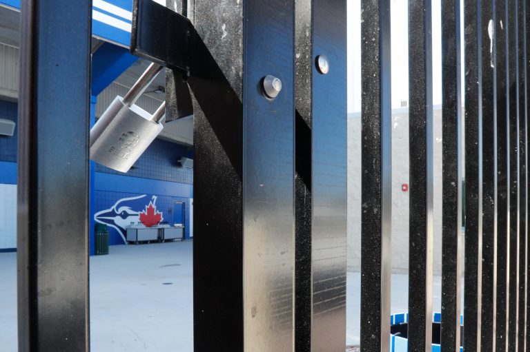 Gates to TD Ballpark, spring training baseball game home of the Toronto Blue Jays are locked, Friday, March 13, 2020, in Dunedin, Fla. Major League Baseball has delayed the start of its season because of the coronavirus outbreak and suspended spring training.