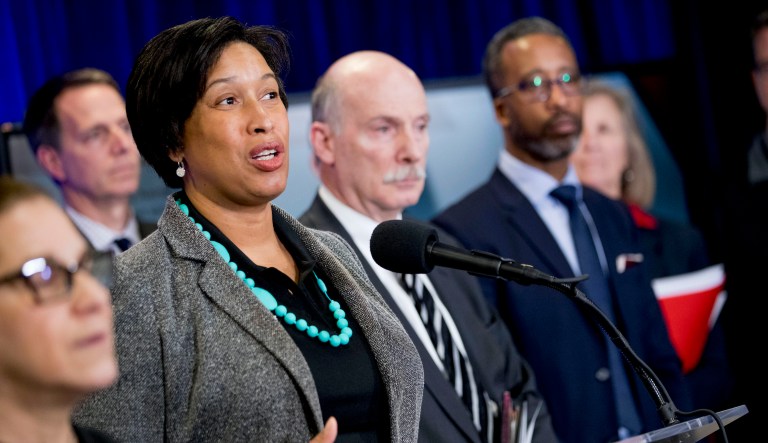 District of Columbia Mayor Muriel Bowser, accompanied by DC Council Chairman Phil Mendelson, second from right, and Councilmember Kenyan McDuffie, right, speaks at a news conference on city updates in response to the coronavirus at the University of the District of Columbia Community College, Friday, March 13, 2020, in Washington.