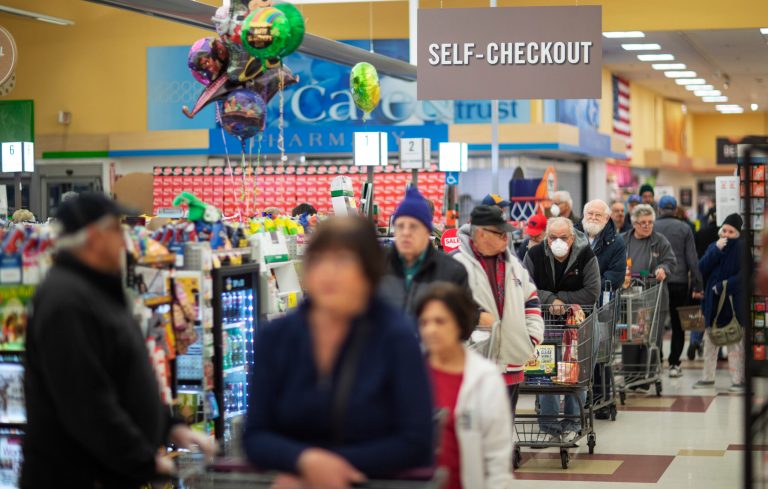 Shoppers wait in the checkout line at a Stop & Shop supermarket during hours open daily only for seniors Thursday, March 19, 2020, in North Providence, R.I. Police have noticed a "disturbing trend" of teens coughing on food and posting their pranks online.