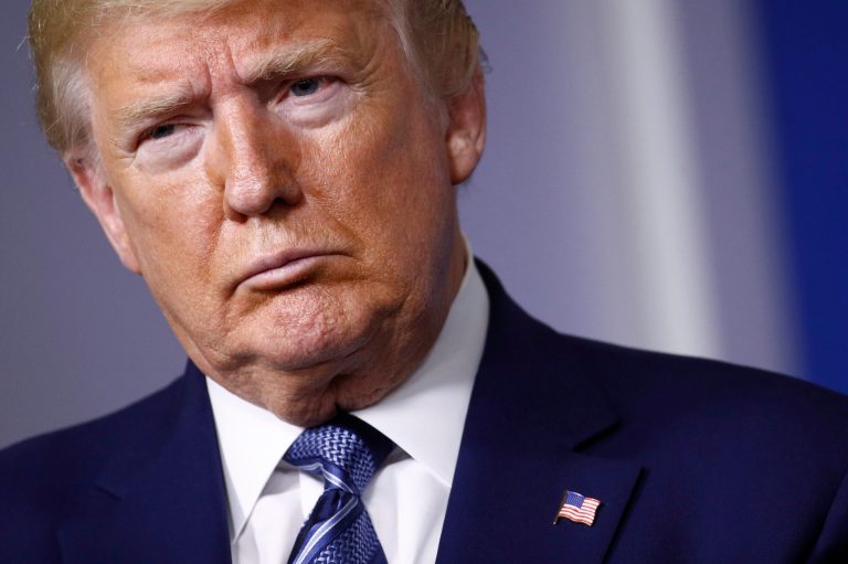 President Donald Trump attends a coronavirus task force briefing at the White House, Sunday. A new survey finds that voters aren't ready to blame him for the virus crisis.