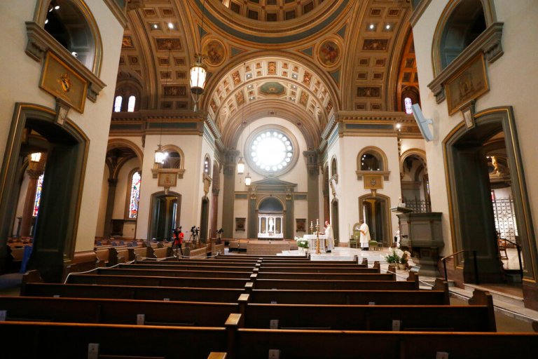 Bishop Barry C. Knestout, at altar, conducts an Easter Sunday Mass in an empty sanctuary at the Cathedral of the Sacred Heart on April 12, 2020, in Richmond, Va.