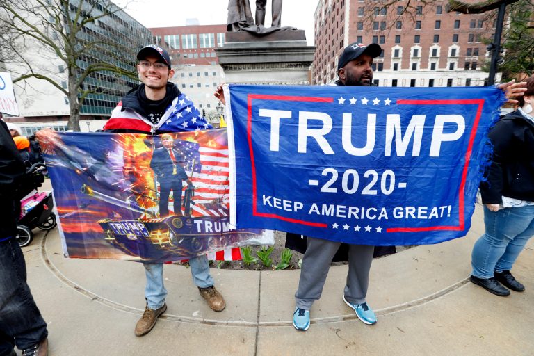 Protesters hold banners supporting President Trump at the State Capitol in Lansing, Mich., Thursday, April 30, 2020.