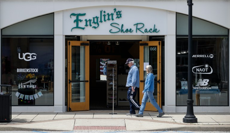 Customers walk past an open shoe store in the Hamilton Town Center in Noblesville, Ind., Monday, May 4, 2020.