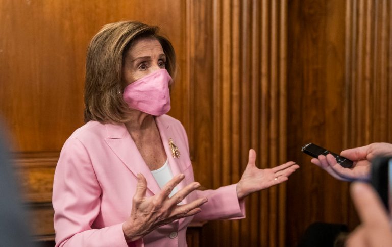 House Speaker Nancy Pelosi of Calif., talks to reporters on Capitol Hill, Tuesday. A new survey finds Democrats are more depressed over the virus, in part because they feel public officials haven't done enough to fight it.