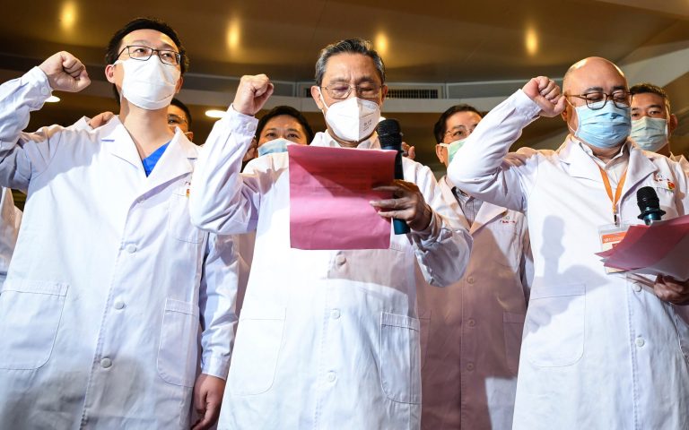 In this March 2, 2020 photo released by Xinhua News Agency, respiratory specialist Zhong Nanshan attends a ceremony for two new probationary Communist Party members in Wuhan to take the oath of joining the Communist Party of China. On Jan. 20, Zhong declared publicly for the first time that the new virus was spreading between people.
