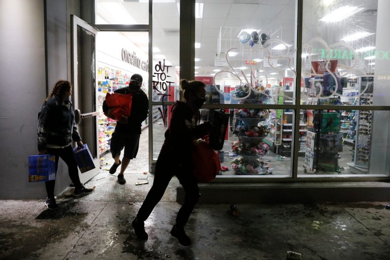 People loot a CVS store during a protest over the death of George Floyd Saturday, May 30, 2020, in Los Angeles. Floyd died in police custody Monday in Minneapolis.