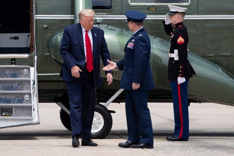President Donald Trump declines to shake the hand of U.S. Air Force Col. Donald Schmidtas he steps off Marine One before boarding Air Force One Saturday. The two laughed about it.