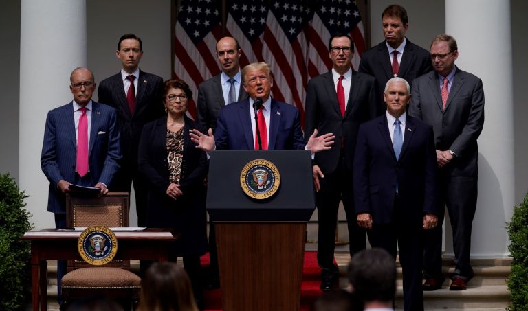 Thomas Philipson (back row, right) appears with the president and senior officials in the White House rose garden in June