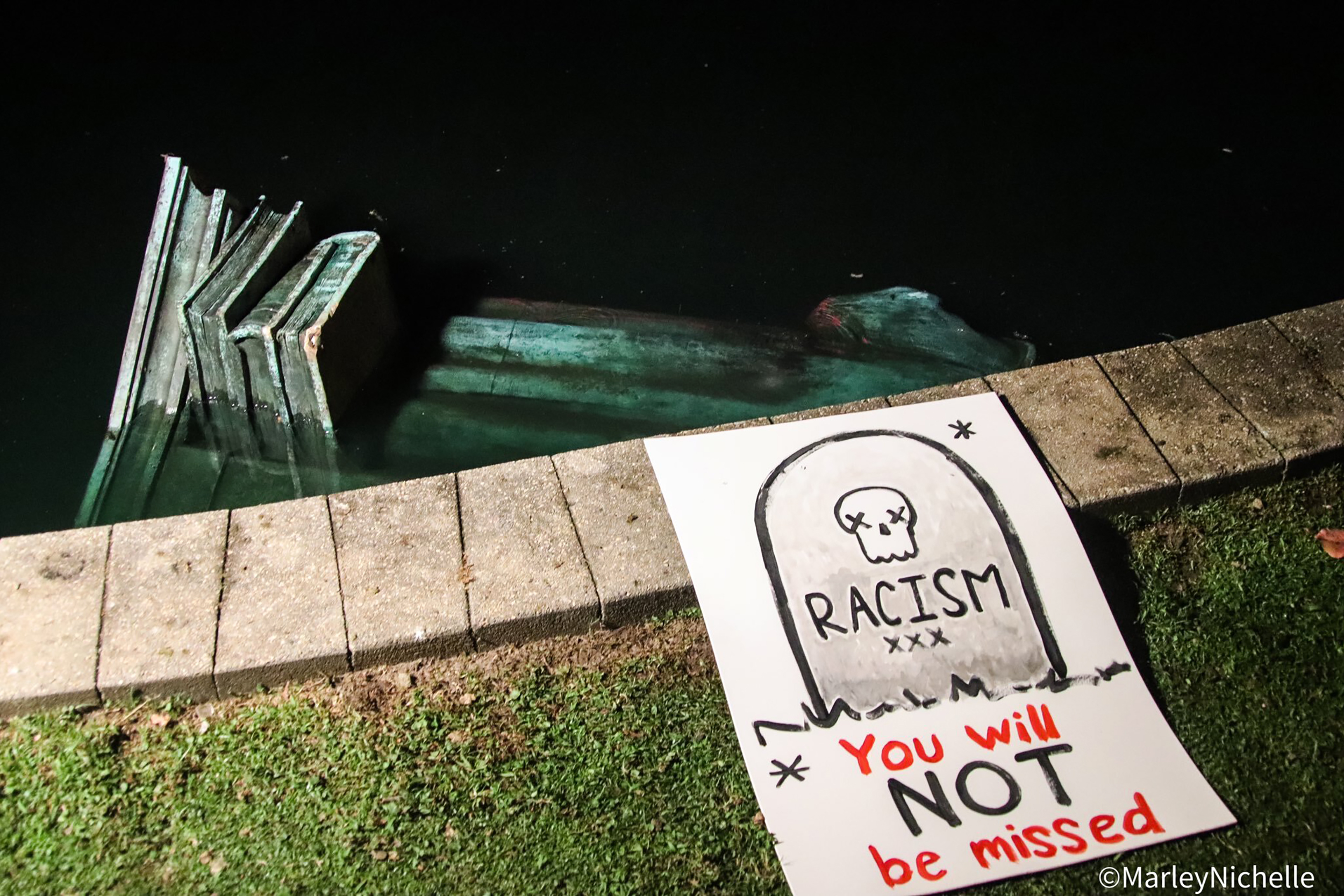 Statue of Christopher Columbus torn down, set on fire, and thrown in lake during protests in wake of George Floyd death