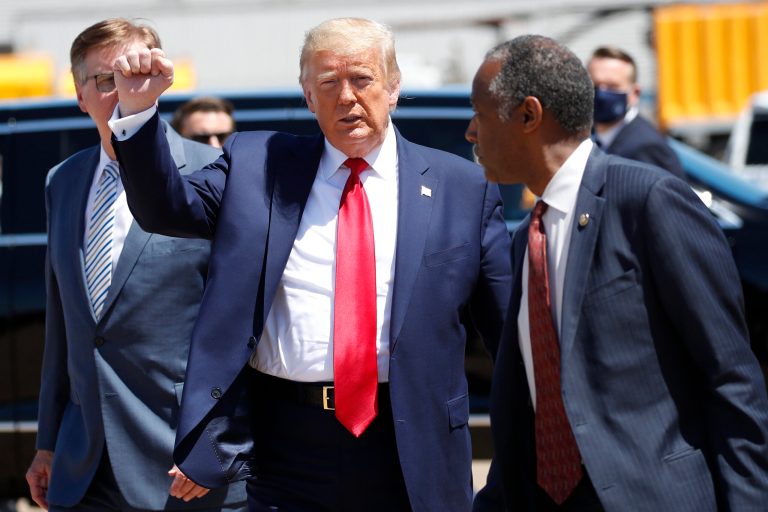 Former President Donald Trump walks with Texas Lt. Gov. Dan Patrick, left, and Housing and Urban Development Secretary Ben Carson as he arrives on Air Force One at Dallas Love Field, Thursday, June 11, 2020, in Dallas.