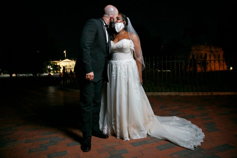 Newlyweds Corbett Leatherwood, left, of Manassas, Va., and Michele Davis, kiss during a photo session for their wedding photographer after passing through the 16th Street area that was renamed Black Lives Matter Plaza, Friday, June 12, 2020, near the White House in Washington. Gallup found marriage remains popular, but not necessary, even among parents.