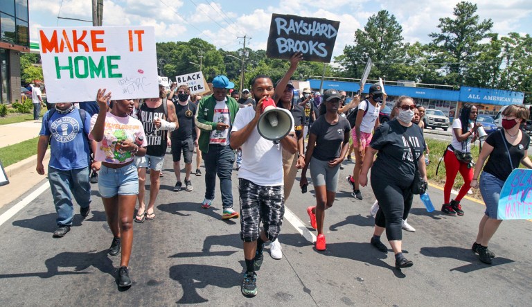 Protestors gather on University Avenue near a Wendy's restaurant on Saturday in Atlanta. Georgia authorities said Saturday that a man was shot and killed in a late-night struggle with Atlanta police outside a fast food restaurant after he failed a field sobriety test and resisted arrest. 