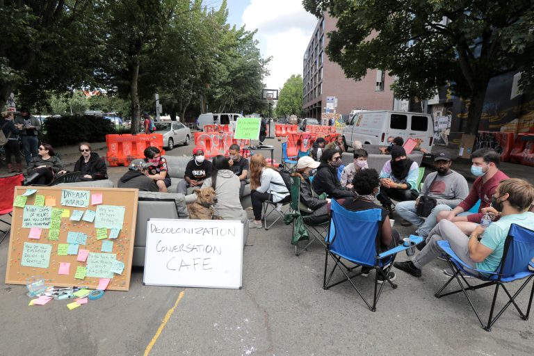 People sit in circles and have conversations at an area dubbed the "Decolonization Conversation Cafe," inside what has been named the Capitol Hill Occupied Protest zone in Seattle. 