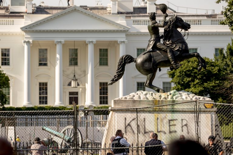 The White House is visible behind a statue of President Andrew Jackson in Lafayette Park, Tuesday, June 23, 2020, in Washington, with the word "Killer" spray painted on its base. Protesters tried to topple the statue.