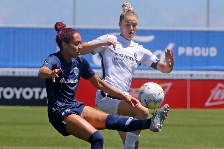 North Carolina Courage defender Jaelene Daniels (left) and Portland Thorns FC defender Christen Westphal battle for the ball during the second half of an NWSL Challenge Cup soccer match at Zions Bank Stadium in June 2020.