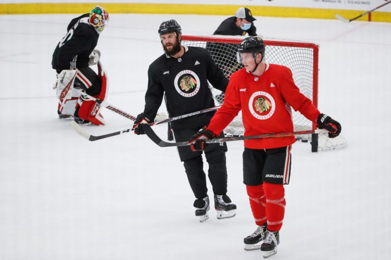 Chicago Blackhawks' Brent Seabrook, center, and Connor Murphy, right, skate during NHL hockey practice at Fifth Third Arena on Monday, July 13, 2020, in Chicago. The Blackhawks play full-contact hockey. A state lawmaker wants the Illinois Department of Public Health to reconsider non-contact hockeyâs classification as a higher risk for the coronavirus. (AP Photo/Kamil Krzaczynski)