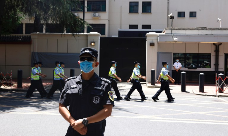 Chinese policemen march past the former United States Consulate in Chengdu in southwest China's Sichuan province on Monday, July 27, 2020. China ordered the United States on Friday to close its consulate in the western city of Chengdu, ratcheting up a diplomatic conflict at a time when relations have sunk to their lowest level in decades.