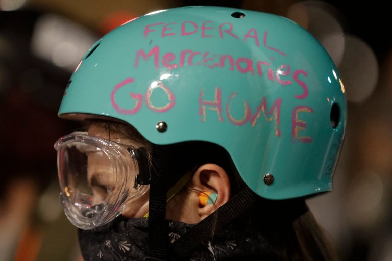 A demonstrator's helmet reads "Federal Mercenaries Go Home" during a Black Lives Matter protest at the Mark O. Hatfield United States Courthouse Sunday in Portland, Ore.
