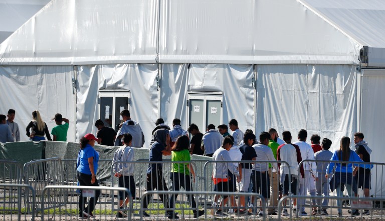 Children line up to enter a tent at the Homestead Temporary Shelter for Unaccompanied Children in Homestead, Florida.
