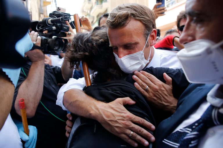 French President Emmanuel Macron hugs a resident as he visits a devastated street of Beirut, Lebanon, Thursday Aug.6, 2020. French President Emmanuel Macron has arrived in Beirut to offer French support to Lebanon after the deadly port blast.