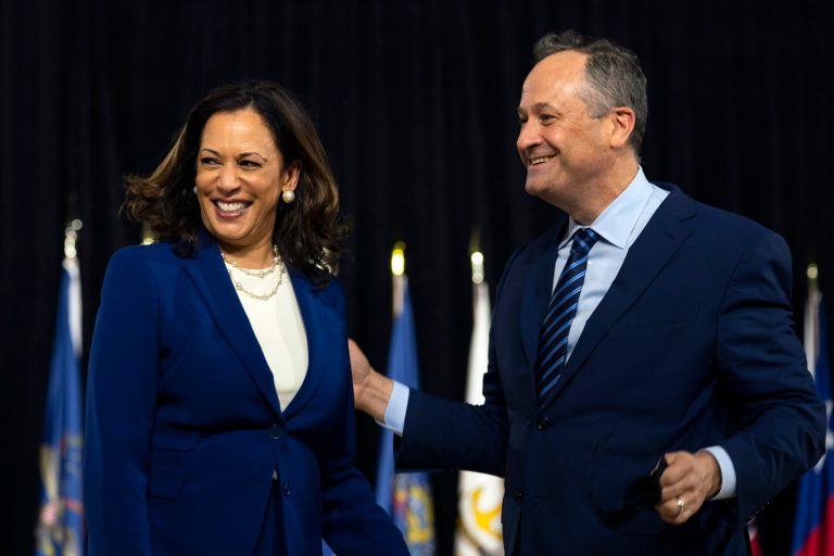Democratic presidential candidate former Vice President Joe Biden's running mate Sen. Kamala Harris, D-Calif., and her husband Douglas Emhoff stand together during a campaign event at Alexis Dupont High School in Wilmington, Del., Wednesday.