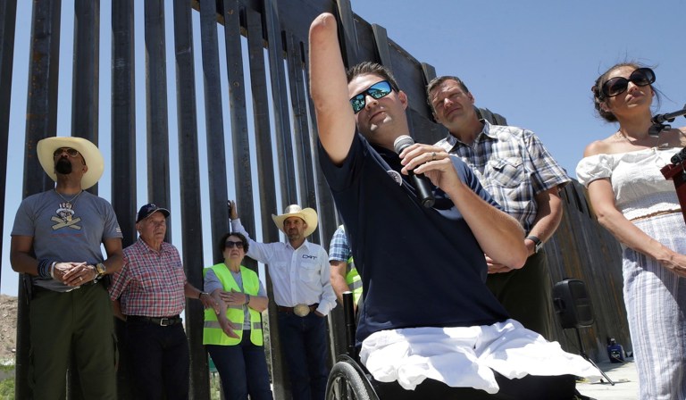 In this May 30, 2019 file photo, Brian Kolfage, founder of We Build the Wall Inc., speaks at a news conference in Sunland Park, N.M., where a privately funded wall is being constructed. Former White House adviser Steve Bannon was arrested Thursday, Aug. 20, 2020, on charges that he and three others, including Kolfage, ripped off donors to the online fundraising scheme âWe Build The Wall.â