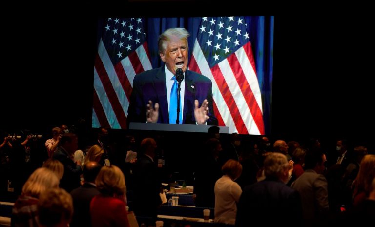 A screen displays President Donald Trump as he speaks on stage during the first day of the Republican National Committee convention in Charlotte.