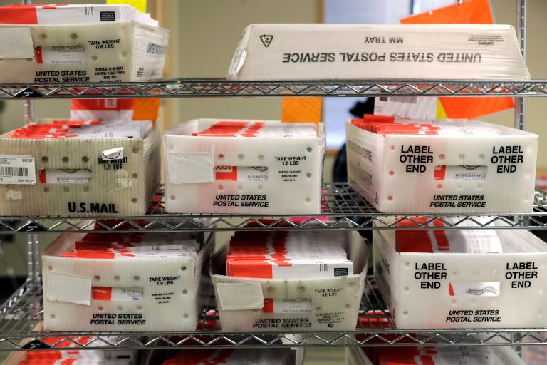 FILE - In this Aug. 5, 2020, file photo, vote-by-mail ballots are shown in U.S. Postal service sorting trays the King County Elections headquarters in Renton, Wash., south of Seattle. (AP Photo/Ted S. Warren, File)