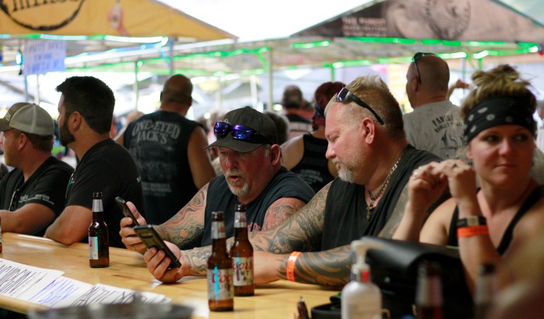 FILE - In this Aug. 7, 2020, file photo, people congregate at One-Eyed Jack's Saloon during the 80th annual Sturgis Motorcycle Rally in Sturgis, S.D. Coronavirus infections in the Dakotas are growing faster than anywhere else in the nation. Infections have been spurred by schools and universities reopening and mass gatherings like the Sturgis Motorcycle Rally, which drew hundreds of thousands of people from across the country.
