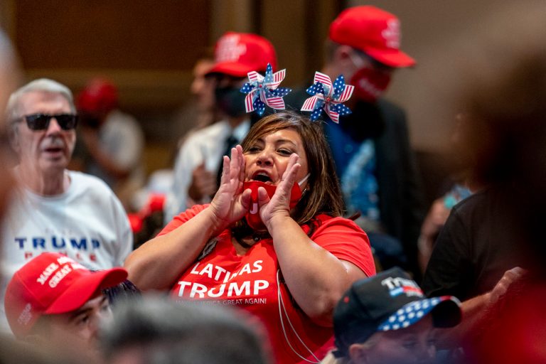 Supporters react to music before President Donald Trump arrives at a Latinos for Trump Coalition roundtable at Arizona Grand Resort & Spa, Monday, Sept. 14, 2020, in Phoenix.