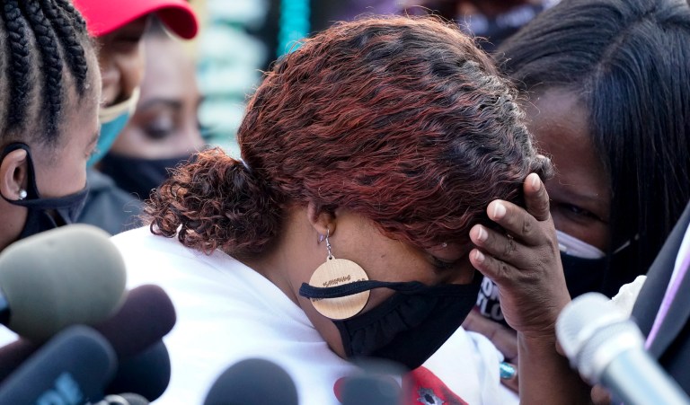 Tamika Palmer, the mother of Breonna Taylor, center, listens to a news conference, Friday, Sept. 25, 2020, in Louisville, Ky. Family attorney Ben Crump is calling for the Kentucky attorney general to release the transcripts from the grand jury that decided not to charge any of the officers involved in the Black womanâs death. 