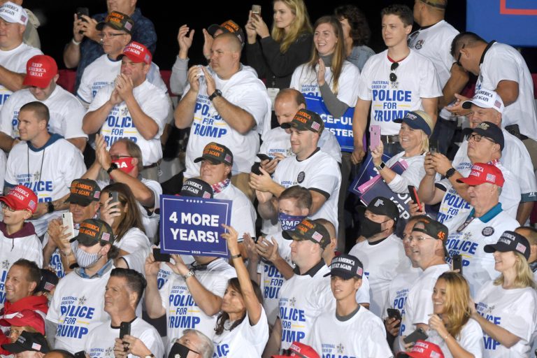 Supporters of President Donald Trump applaud while wearing shirts that read "Fraternal Order of Police for Trump," during a Trump campaign rally at Harrisburg International Airport, Saturday, Sept. 26, 2020, in Middletown, Pa.