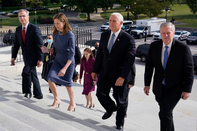 Supreme Court nominee Judge Amy Coney Barrett, second from left, walks up the steps of Capitol Hill in Washington with, from left, White House Counsel Pat Cipollone, Vice President Mike Pence and White House Chief of Staff Mark Meadows, as they arrive on Capitol Hill in Washington, Tuesday, Sept. 29, 2020.