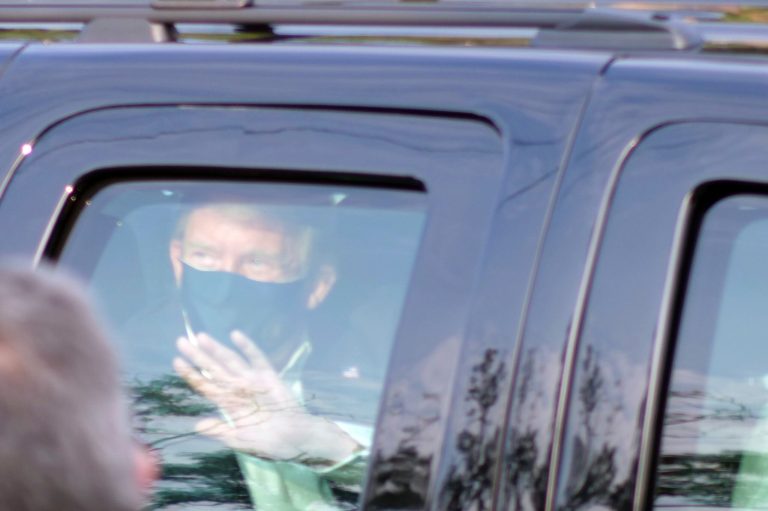 President Donald Trump drives past supporters gathered outside Walter Reed National Military Medical Center in Bethesda, Md., Sunday, Oct. 4, 2020. Trump was admitted to the hospital after contracting COVID-19.