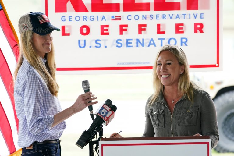 Republican congressional candidate Marjorie Taylor Greene, right, introduces Sen. Kelly Loeffler, R-Ga. during the fall election.
