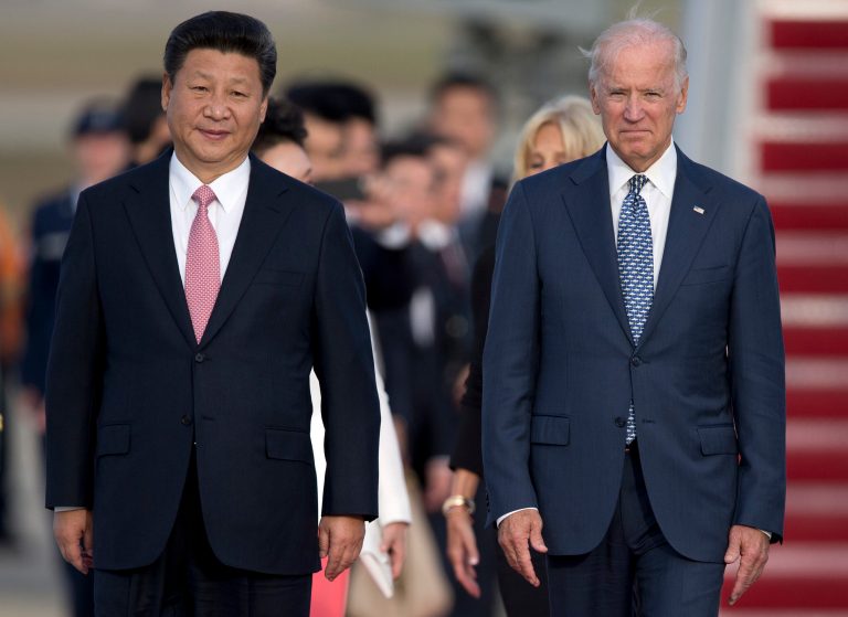 FILE - In this Sept. 24, 2015 file photo, Chinese President Xi Jinping and then Vice President Joe Biden walk down the red carpet on the tarmac during an arrival ceremony in Andrews Air Force Base, Md.  (AP Photo/Carolyn Kaster, File)